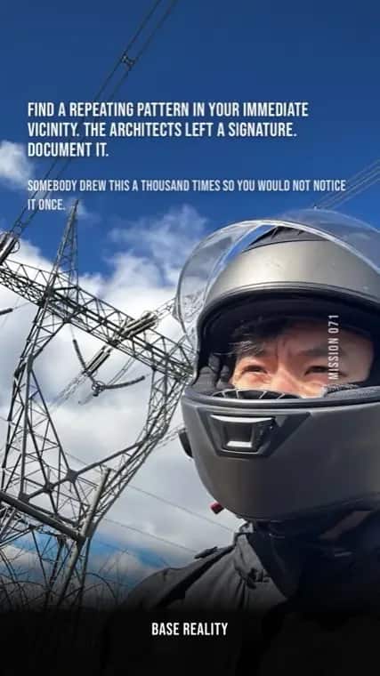 Base Reality mission 71, "Find a repeating pattern in your immediate vicinity. The architects left a signature. Document it.", answered with a helmet selfie beneath a transmission pylon.